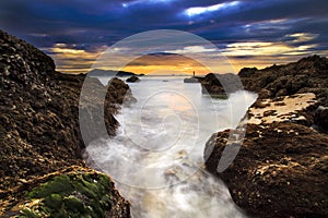 Sea waves lash line impact rock on the beach