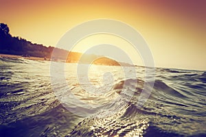 Sea waves and ripples at sunset. First person perspective swimming