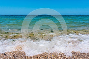 Sea waves roll on to a beach