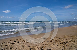 Sea, waves and sand on the beach of Paso Oscuro in Lazio in Italy photo