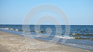 Sea waves smoothly roll onto the sandy shore. Black Sea