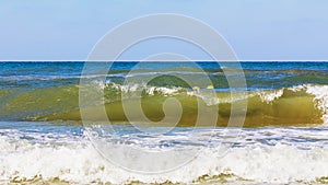 Sea waves during a storm on a sunny day