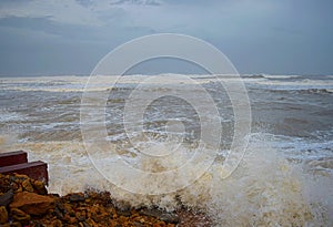 Sea Waves striking Rocks on Shore and Sprinkle of Water Droplets in Air with Cloudy Sky - Vayu Cyclone 2019