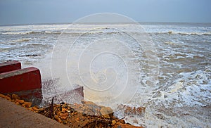 Sea Waves striking Stairs and Rocks on Shore and Shower of Water Droplets in Air with Cloudy Sky - Vayu Cyclone 2019