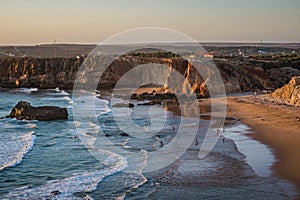 Sea waves with sunset colors on the sand and cliffs of Tonel beach, Sagres - Algarve PORTUGAL