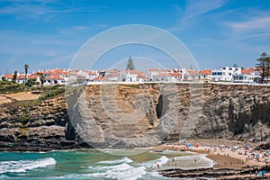 Sea and waves on Zambujeira do Mar beach with village architecture on top of cliff, Odemira - Alentejo PORTUGAL photo