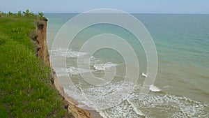 Sea with waves under the hills. Natural coast landscape. Mountain with ocean breze.