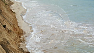 Sea with waves under the hills. Natural coast landscape. Mountain with ocean breze.