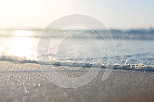 Sea waves and warm sunset light, calm and relaxing sandy beach