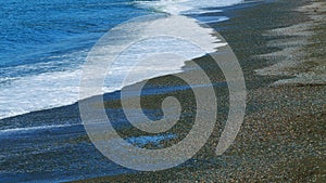 Sea Waves Washes Pebble Beach. Sea Waves Roll Ashore. Nature Concept. Real time.