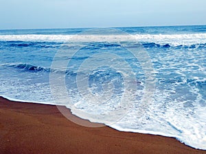 Sea waves and the wet sand