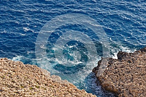 Sea waves on the wild rocky coast. Beautiful seascape. Travel concept. Seascape on the background of the wild rocky coast