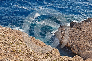 Sea waves on the wild rocky coast. Beautiful seascape. Travel concept. Seascape on the background of the wild rocky coast