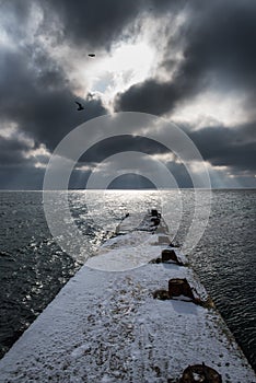 Sea winter landscape. panoramic photo. Old pier in the snow,