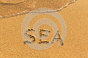 Sea - word drawn on the sand beach
