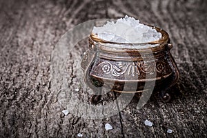 sea â€‹â€‹salt in a large antique salt shaker on old wooden table