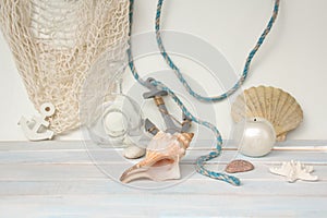 Sea â€‹â€‹shells, blue cord, white fishing net, starfish, pebbles, still life, summer vacation concept, trip to warmer climes,