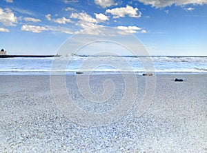 Sea â€‹â€‹surf sky sand sand beach stones on sand