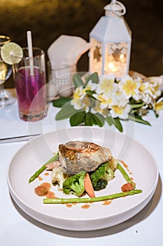 Seabass on a plate during Romantic dinner on beach of Huahin Thailand,