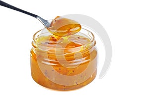 Seabuckthorn jam in glass jare with spoon isolated on a white