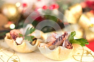 Seafood appetizer inside bread basket on Christmas table