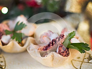 Seafood appetizer inside bread basket on Christmas table