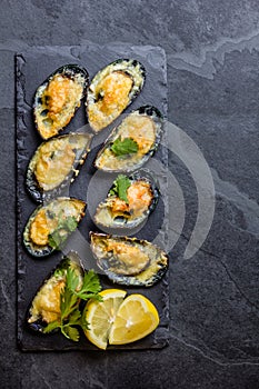 Seafood. Baked mussels with cheese and lemon in shells