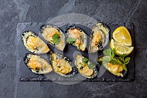 Seafood. Baked mussels with cheese and lemon in shells