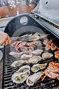 Seafood BBQ  barbecue. Collection of octopus, oysters, clam, tiger shrimps grilled on grill