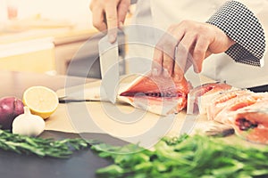 Seafood - chef prepares salmon for cooking