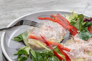 Seafood cocktail on baked potato. Healthy lunch with salad close-up