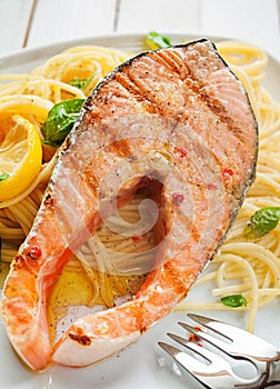Seafood dinner of grilled salmon on linguine