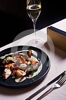 Seafood dish with baby octopus, shrimps, prawns, mussles, squids and creamy sauce. Serving in the restaurant, dinner