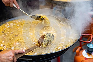 Seafood fideua in large paellera at spanish street festival photo