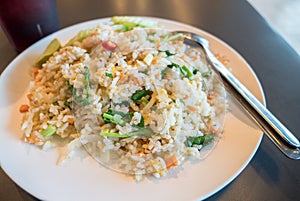 Seafood fried rice wite spoon and folk on table