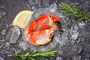 Seafood frozen boiled crab claws - Fresh crab with ingredients lemon rosemary on ice at market