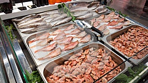 Seafood on ice at the fish market. Fresh raw fish selling in fridge. seafood selling.