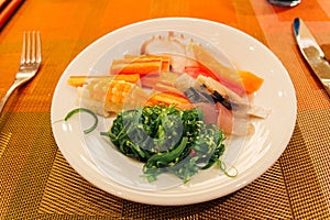 Seafood Japanesse dinner Salmon, Tuna, Crab Stick, Sushi, Seaweed on a plate at the hotel. photo