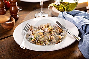 Seafood linguine pasta with clams served with wine