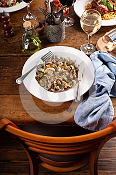 Seafood linguine pasta with clams served with wine