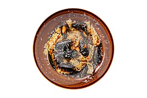 Seafood Mafaldine pasta with mussels and tomato sauce in a rustic plate. Isolated, white background. Top view.