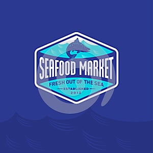 Seafood market or restaurant logo. Blue salmon fish silhouette and blue sea wave.