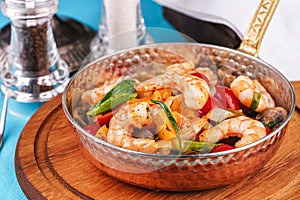 Warm salad of grilled fish pieces, shrimps and mussels in a frying pan