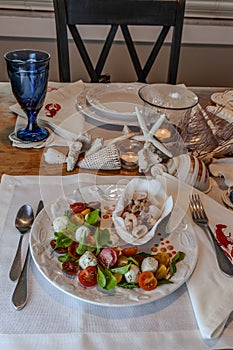 Seafood mix and Caprese salad with cherry tomatoes, mozzarella, basil, and arugula