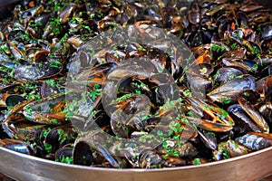 Seafood. Mussels in a large frying pan. Street food. Clams in the shells. Delicious snack for gourmands.
