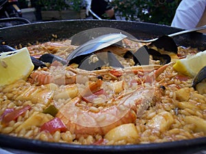 Seafood paella in a frying pan in a street cafe in Barcelona