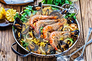 Seafood Paella in the man on a white table with decoration