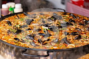 Seafood paella in a paella pan at a street food market