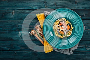 Seafood Pasta. On a wooden background. Italian cuisine.