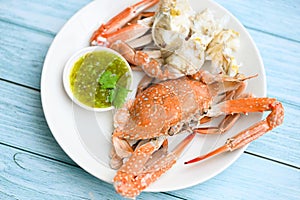 Seafood plate fresh crab cooking on white plate background , blue swimming crab meat claw served on a food table - cooking steamed